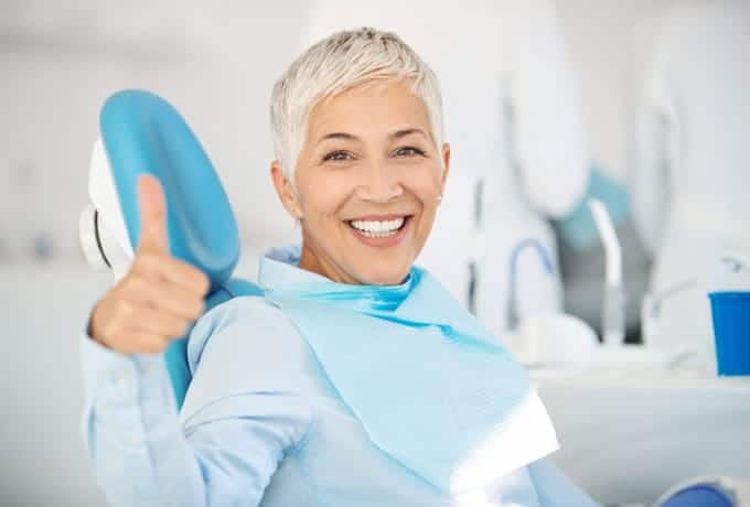 happy patient in dental office chair